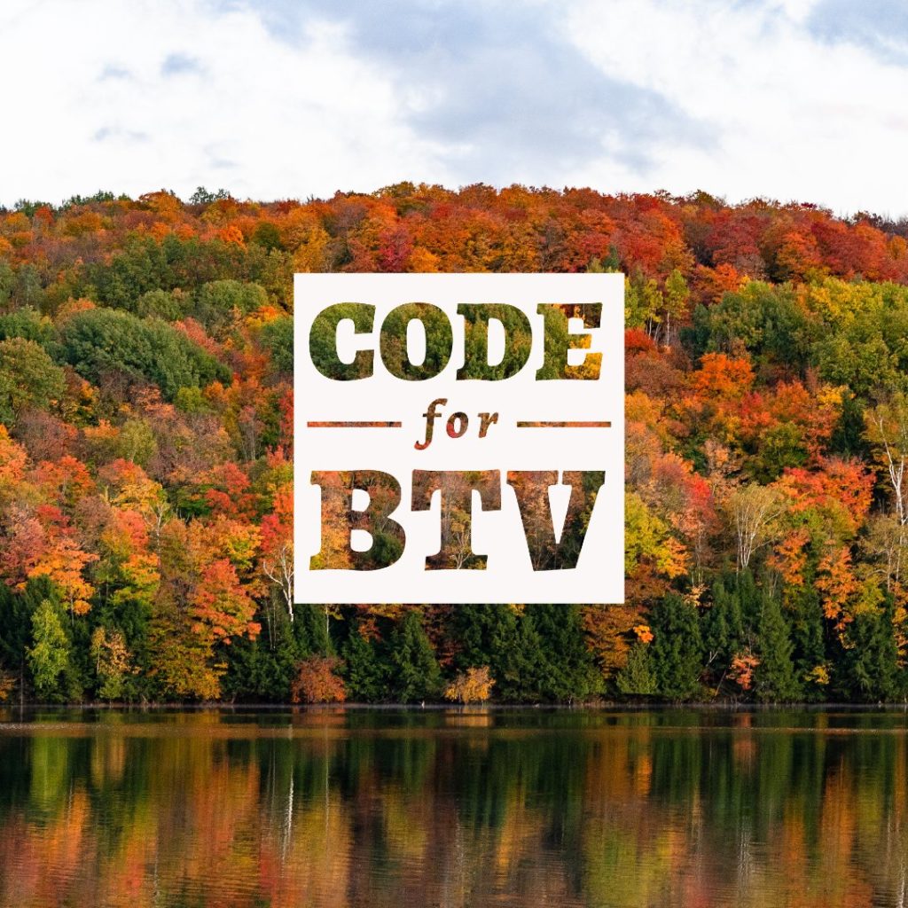White square Code for BTV logo with transparent letters in front of trees with fall foliage.